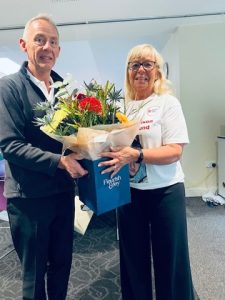 CRY Screening Manager, Tony Hill presenting Debbie with flowers from CRY